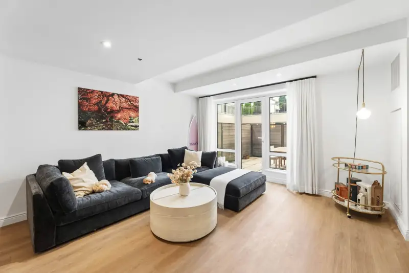 Living room with sectional sofa and glass doors to the private terrace