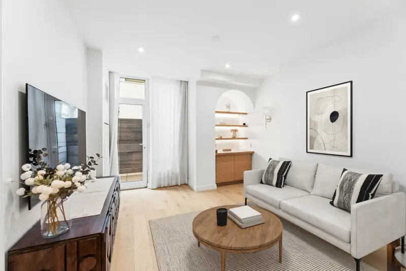 Living room seating area with floor to ceiling windows